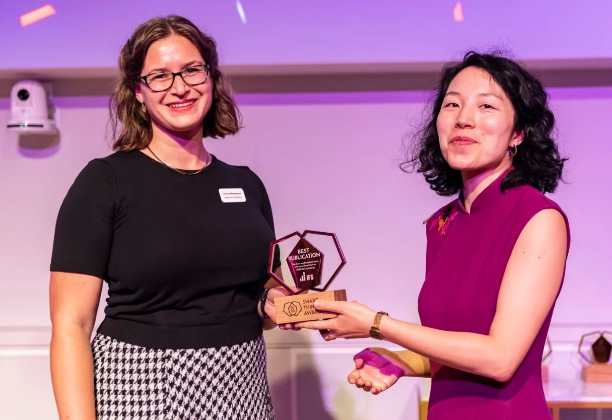 Corporate awards photography — winner receiving a prize on stage at a London event